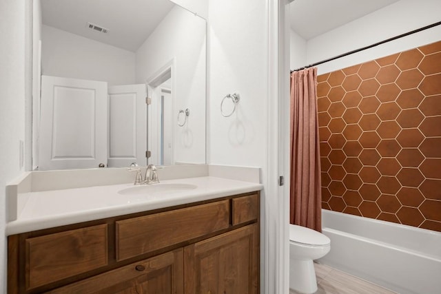 full bathroom featuring vanity, shower / bath combination with curtain, and toilet