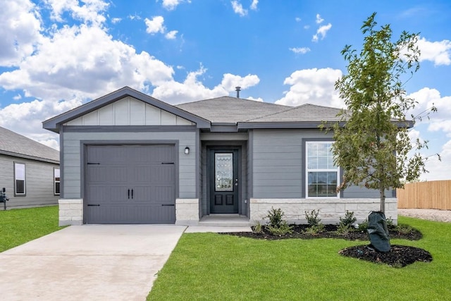 view of front of property featuring a garage and a front lawn