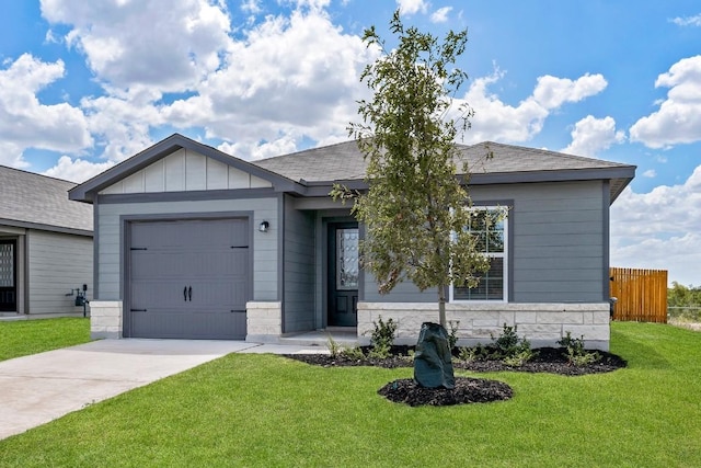 view of front of home featuring a garage and a front lawn