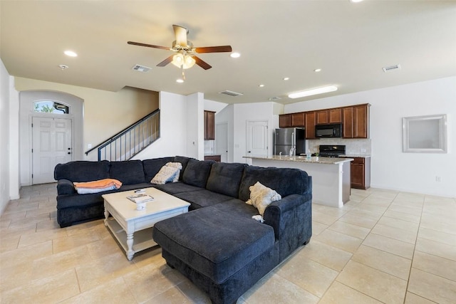 living room with light tile patterned floors and ceiling fan