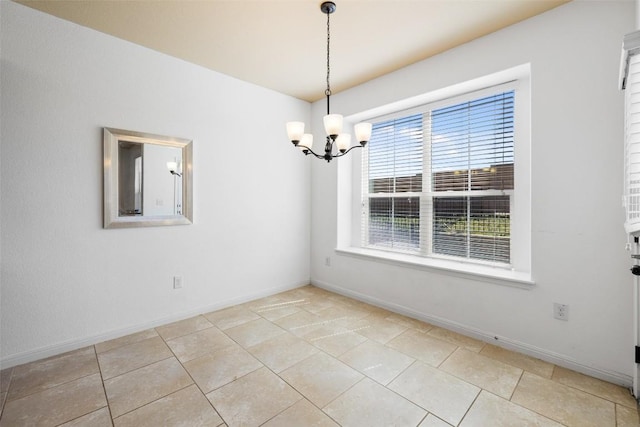 spare room with light tile patterned floors and a chandelier