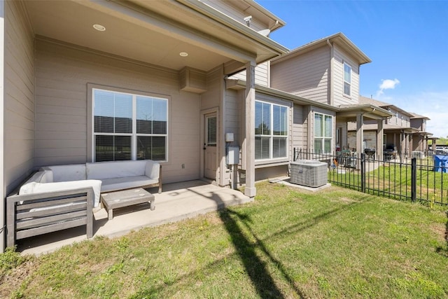 back of property featuring an outdoor living space, a yard, and a patio area