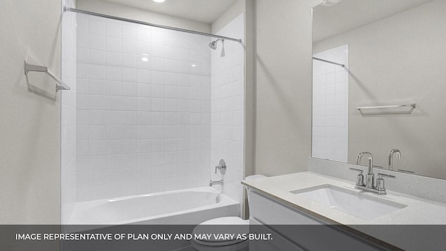 full bathroom with tiled shower / bath, vanity, and toilet