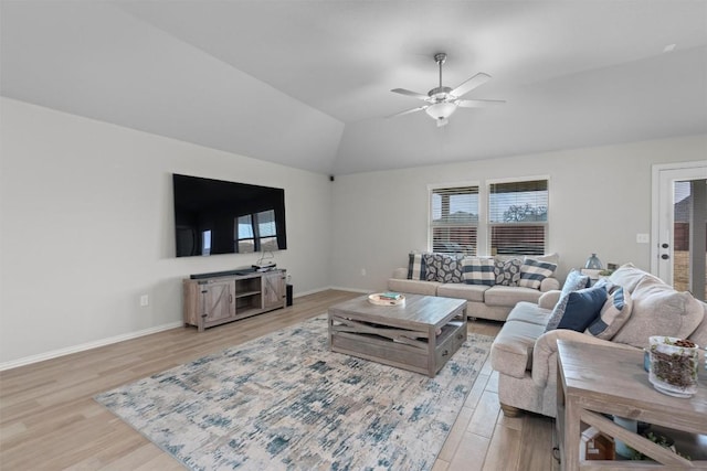 living room featuring vaulted ceiling, ceiling fan, and light hardwood / wood-style floors