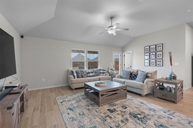 living room featuring ceiling fan, vaulted ceiling, and light wood-type flooring