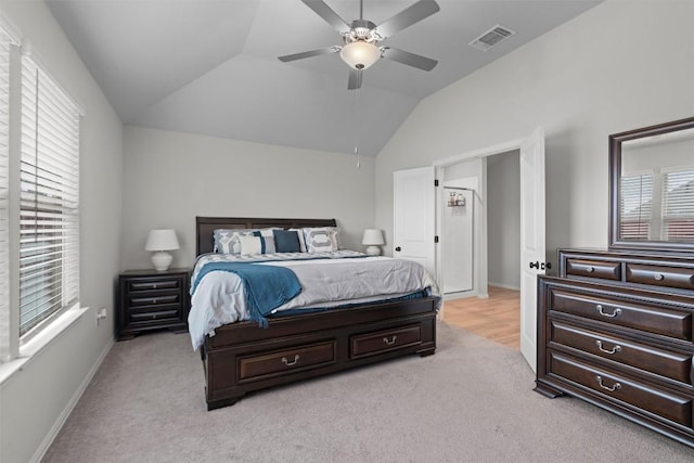 bedroom featuring light carpet, vaulted ceiling, and ceiling fan