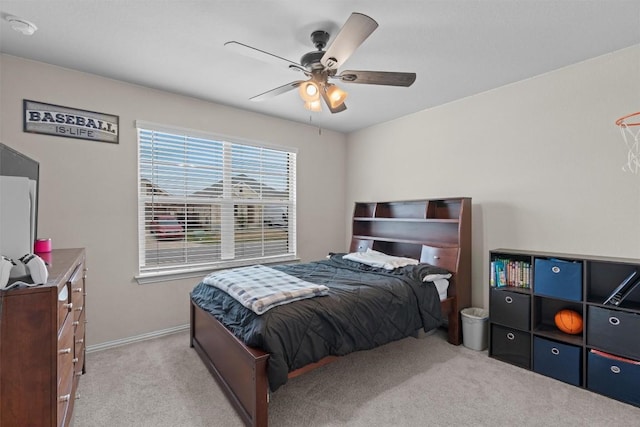 bedroom featuring light carpet and ceiling fan