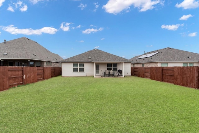 rear view of house featuring a patio area and a lawn