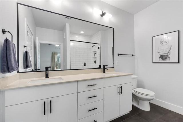 bathroom featuring vanity, tile patterned flooring, a shower with door, and toilet