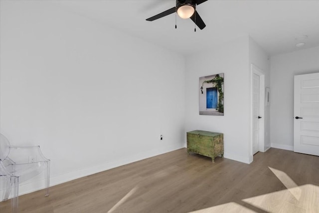 living room with ceiling fan and light hardwood / wood-style floors