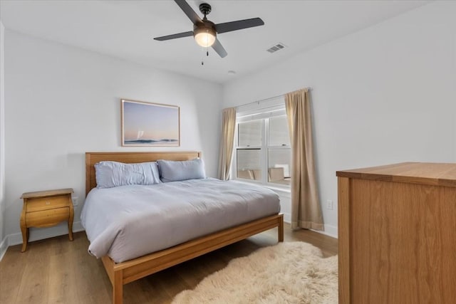 bedroom featuring light hardwood / wood-style floors and ceiling fan