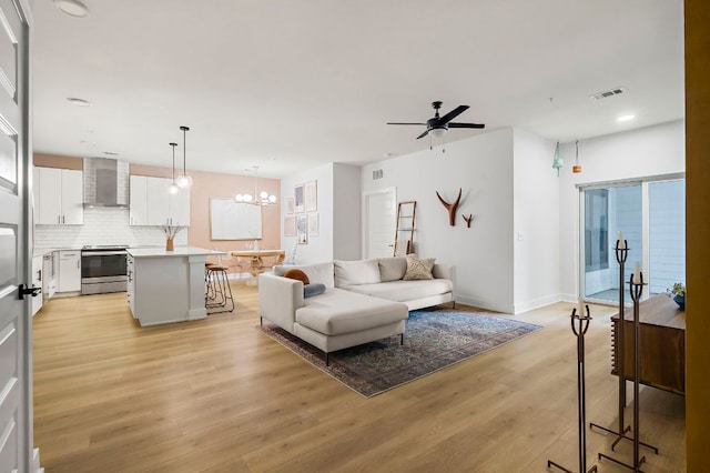 3101 Govalle Ave Unit 106, Austin, TX 78702 - living room featuring visible vents, light wood-type flooring, baseboards, ceiling fan with notable chandelier, and recessed lighting