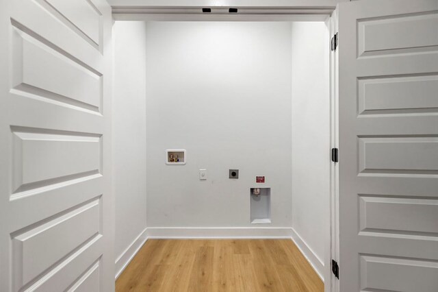 3101 Govalle Ave Unit 106, Austin, TX 78702 - laundry room featuring laundry area, light wood-style floors, baseboards, electric dryer hookup, and washer hookup