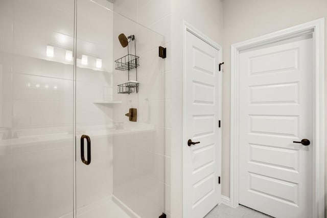 bathroom with a shower with shower door