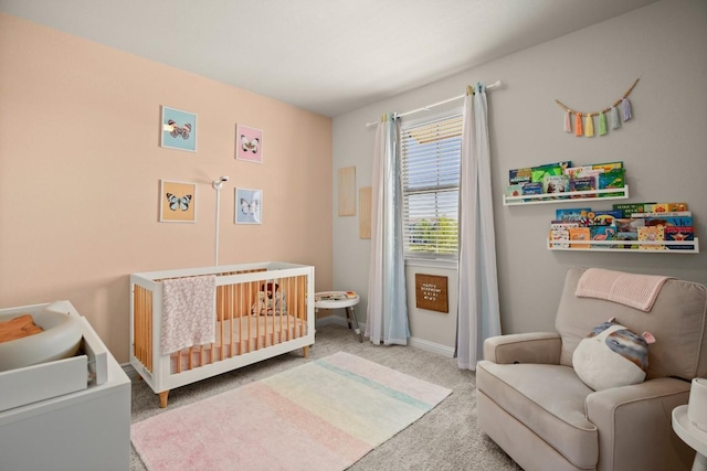 bedroom featuring carpet and a crib