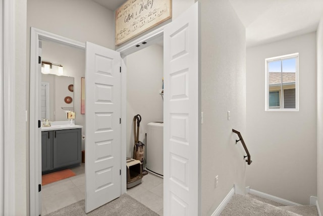 bathroom featuring vanity and washer / dryer