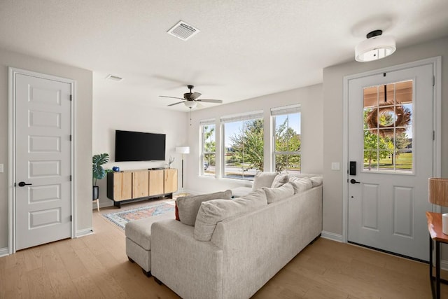 living room featuring ceiling fan and light wood-type flooring