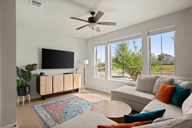 living room with ceiling fan and light wood-type flooring