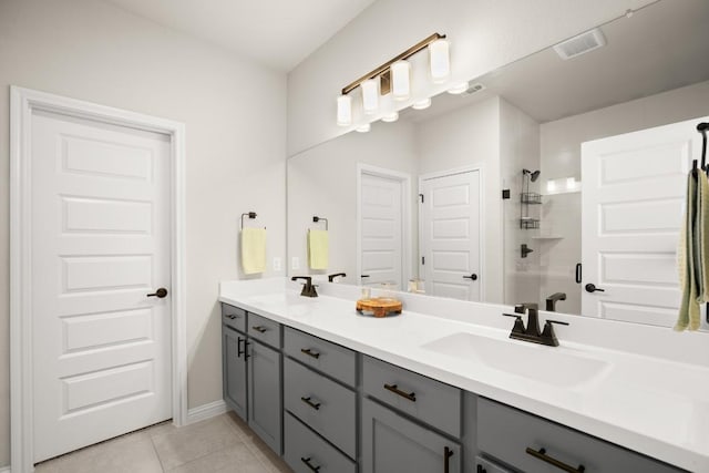 bathroom with vanity, an enclosed shower, and tile patterned flooring