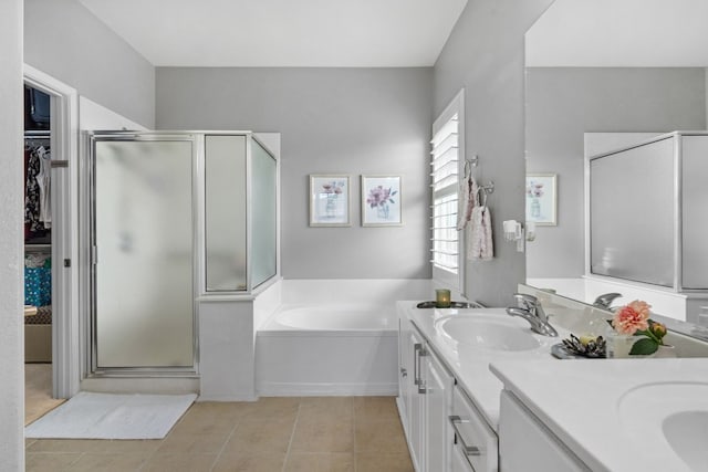 bathroom with tile patterned floors, independent shower and bath, and vanity