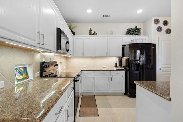 kitchen with dark stone countertops, tasteful backsplash, black appliances, white cabinets, and light tile patterned flooring