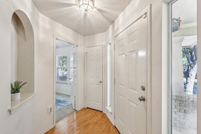 entryway with light hardwood / wood-style flooring and a textured ceiling