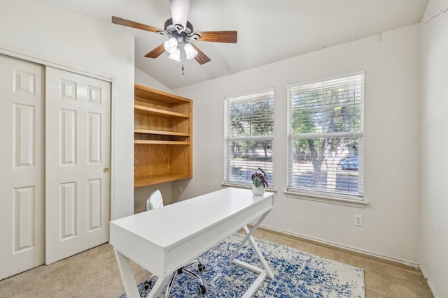 office space featuring ceiling fan, vaulted ceiling, and light carpet