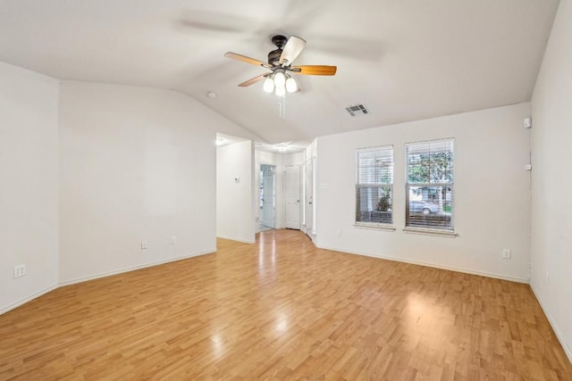 spare room featuring vaulted ceiling, ceiling fan, and light wood-type flooring