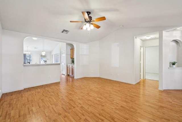 unfurnished living room featuring vaulted ceiling, light hardwood / wood-style floors, and ceiling fan