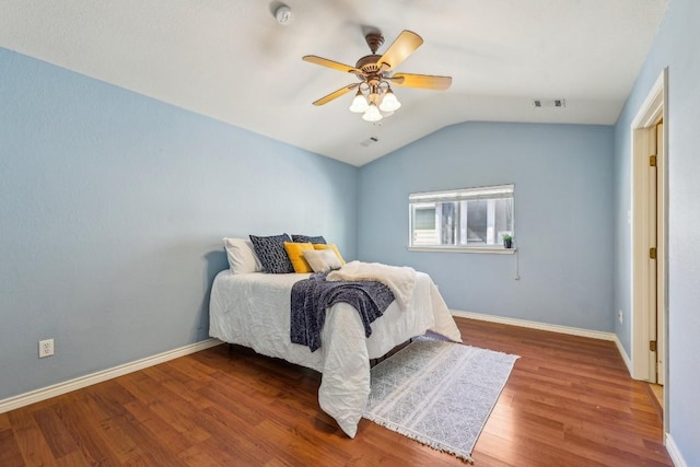 bedroom with ceiling fan, wood-type flooring, and vaulted ceiling