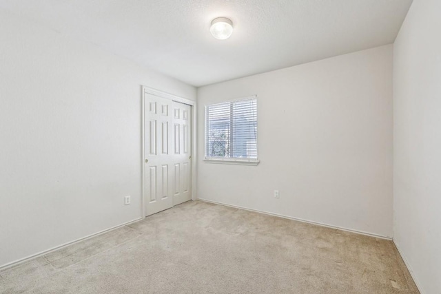 unfurnished room with light carpet