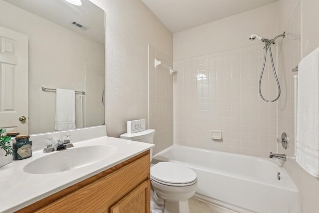 full bathroom with vanity, tiled shower / bath, and toilet