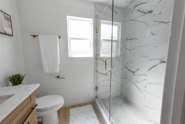 bathroom featuring vanity, toilet, and a shower with shower door