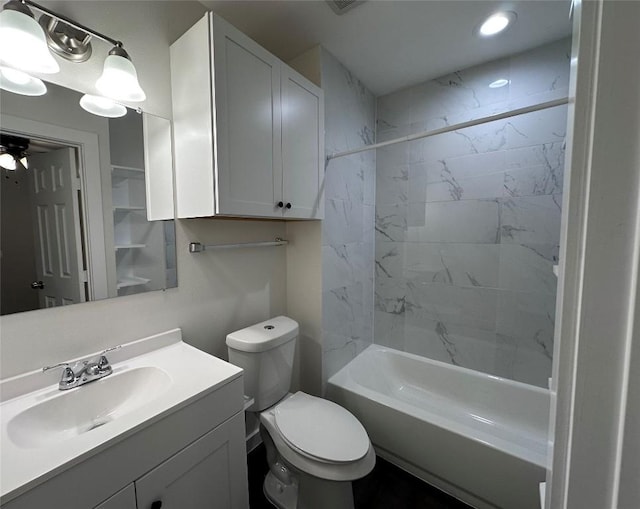 full bathroom featuring tiled shower / bath combo, vanity, and toilet