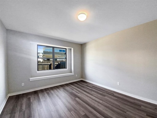 spare room featuring dark hardwood / wood-style floors