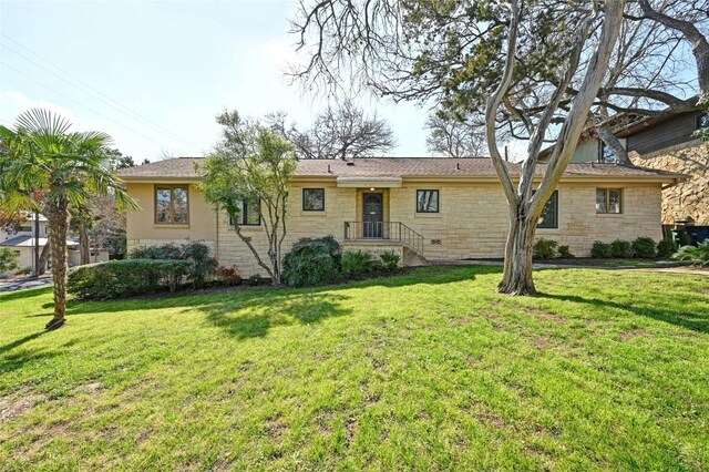 3401 Clearview Dr, Austin, TX 78703 - view of front facade featuring stone siding and a front lawn