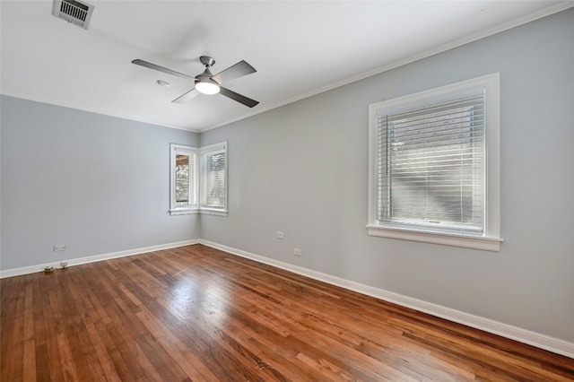 empty room featuring crown molding, hardwood / wood-style floors, and ceiling fan