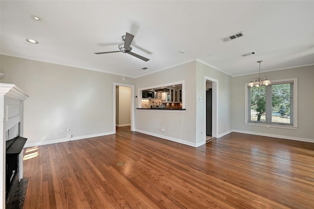 unfurnished living room with crown molding, dark hardwood / wood-style floors, and ceiling fan with notable chandelier