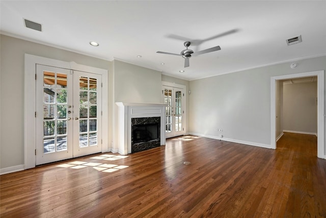 unfurnished living room with french doors, a healthy amount of sunlight, and a fireplace