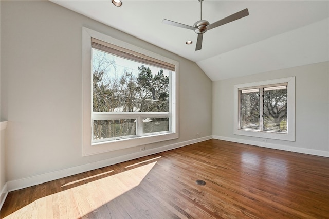 additional living space with ceiling fan, lofted ceiling, and dark hardwood / wood-style floors