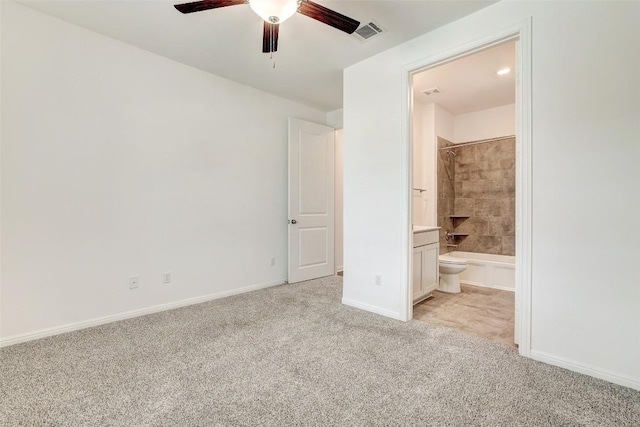 unfurnished bedroom with light colored carpet, ceiling fan, and ensuite bathroom