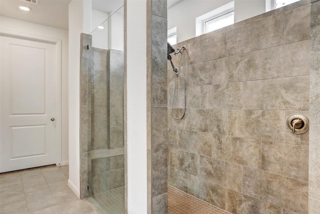 bathroom featuring a tile shower and tile patterned floors