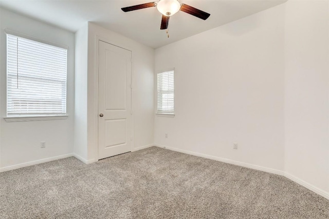 carpeted empty room with ceiling fan