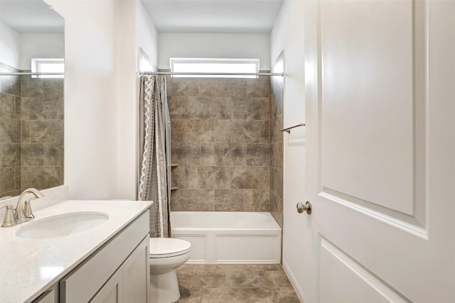 full bathroom featuring vanity, shower / tub combo with curtain, and toilet