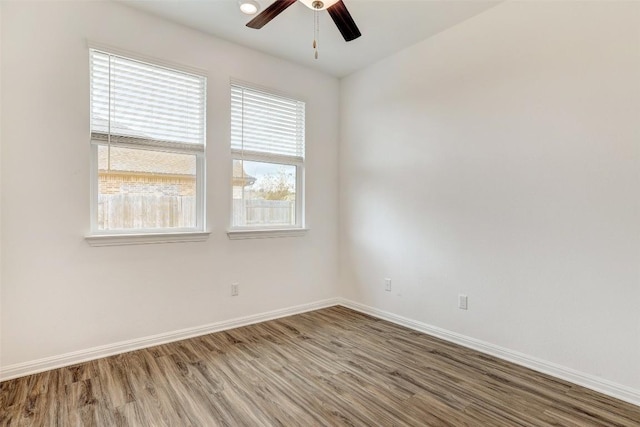 spare room featuring hardwood / wood-style flooring and ceiling fan