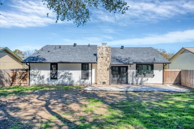 back of property with a yard and a patio area