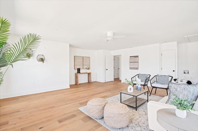 living room featuring light hardwood / wood-style floors and ceiling fan