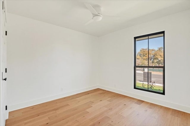 empty room with ceiling fan and light hardwood / wood-style floors