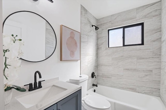 full bathroom featuring vanity, toilet, and tiled shower / bath