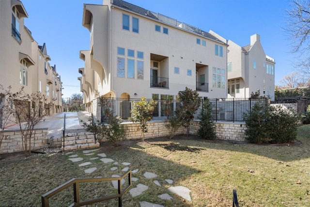 rear view of house featuring a yard